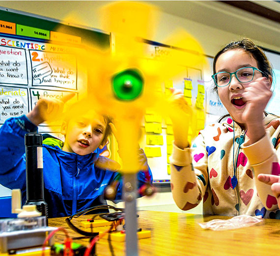 Elementary students in classroom working with climate kits