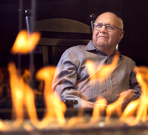 Blaine Garvin sits next to the Hemmingson fireplace.